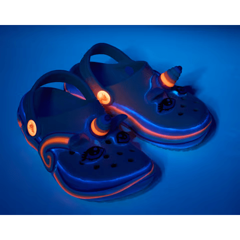 Glowing blue children's sandals with a unicorn design on a blue background