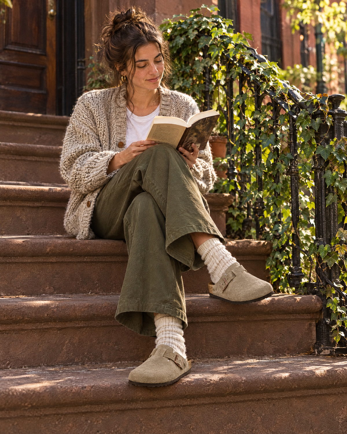 Woman on a Brooklyn brownstone stoop wearing Birkenstock Boston suede clogs